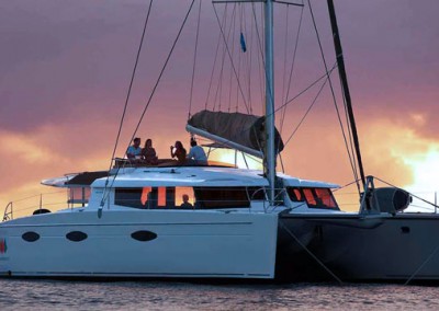 Nigel James Sailing in a Chartered Catamaran at sunset