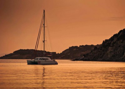 Crewed Sailing Yacht Catamaran at sunset