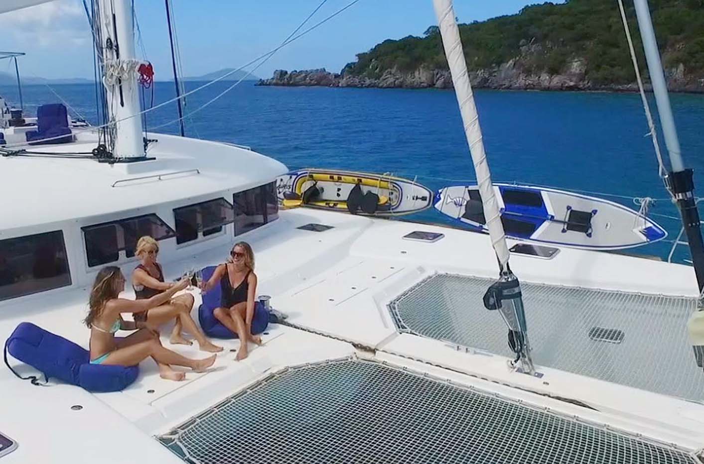 Drinks on the foredeck of crewed catamaran Serenity Now in the Caribbean